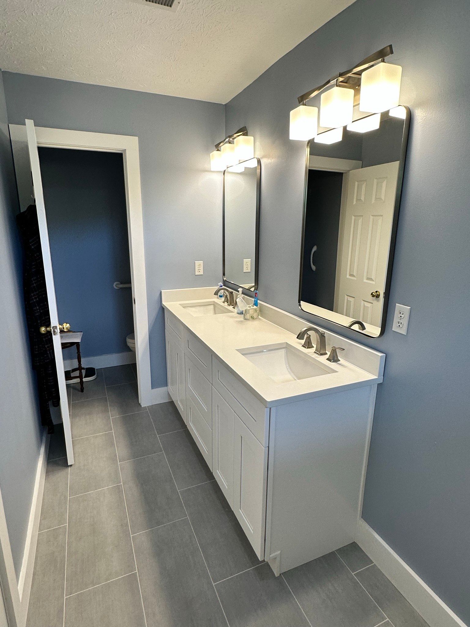 A bathroom with two sinks and two mirrors.