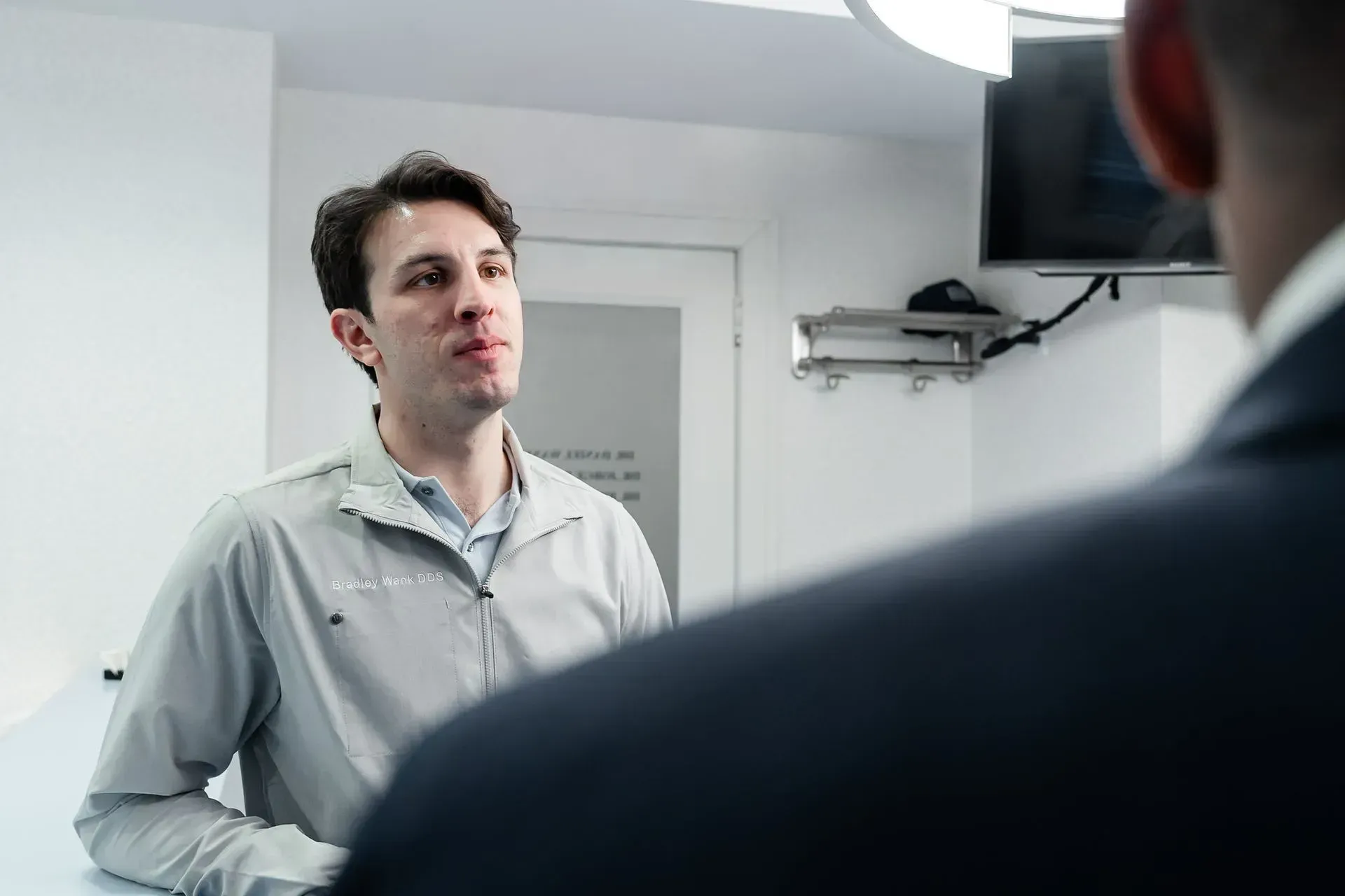 Dr. Bradley Wank talking with a patient in the office