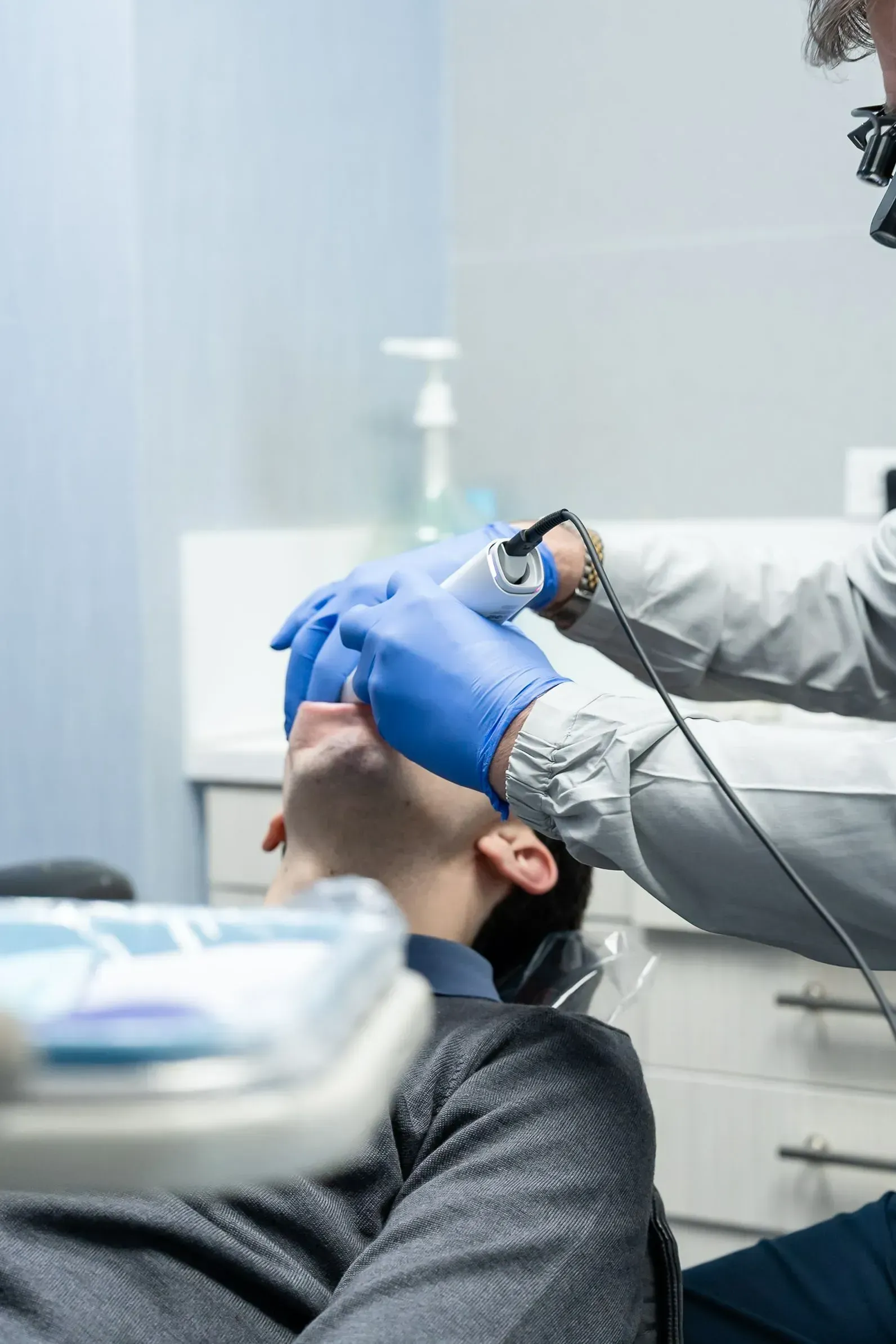 A patient reclined in the dental chair during treatment