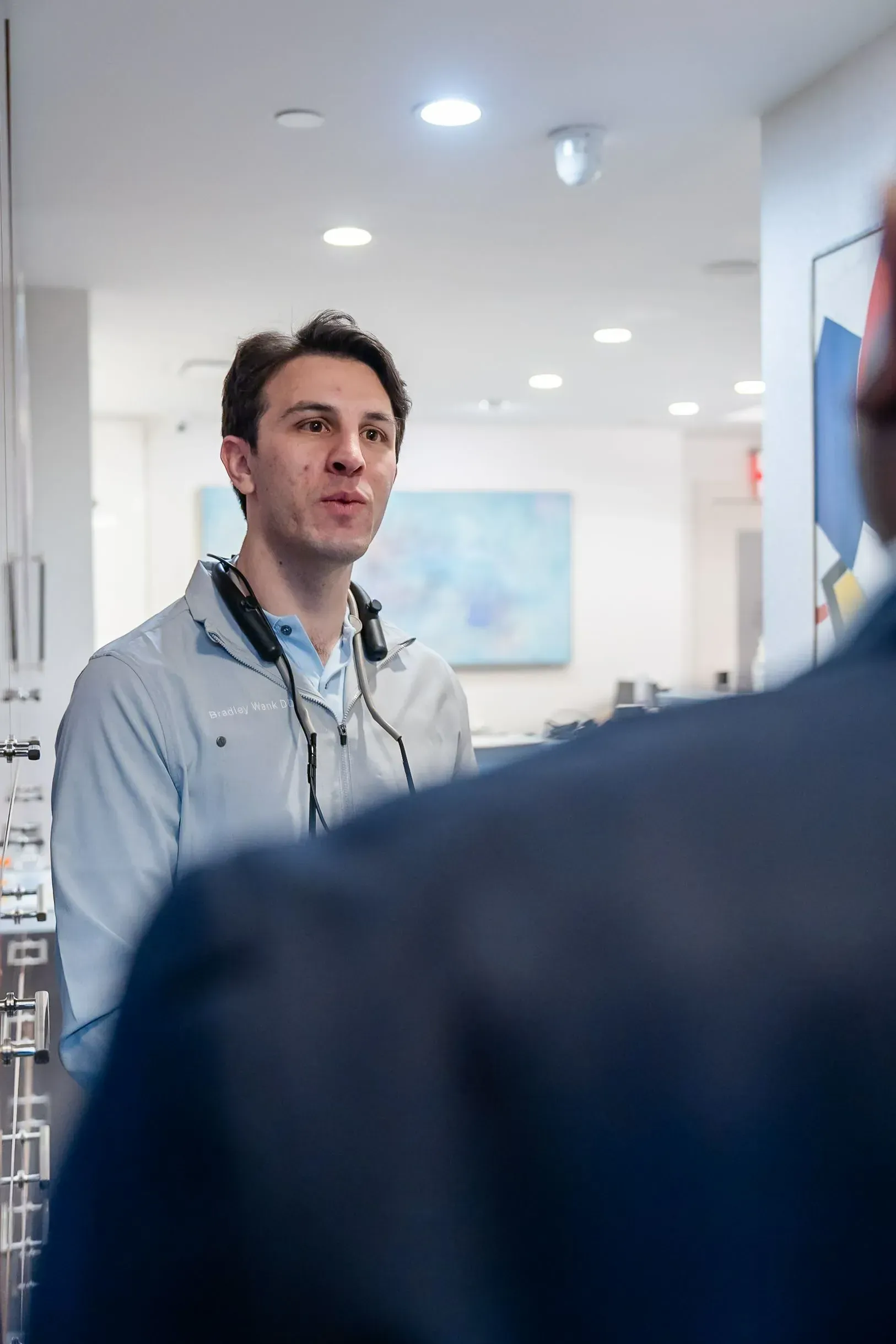 Dr. Bradley Wank listening to a patient