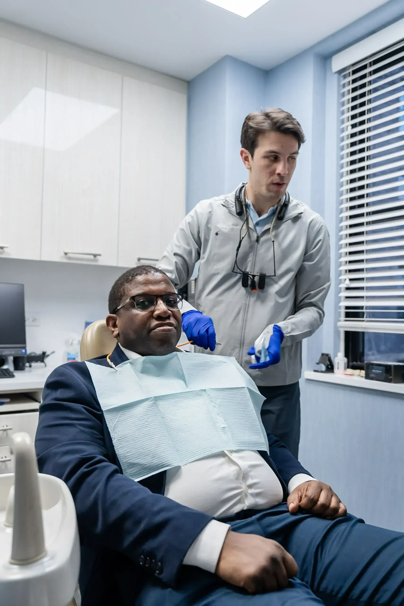 A smiling patient in the dental chair with Dr. Bradley Wank