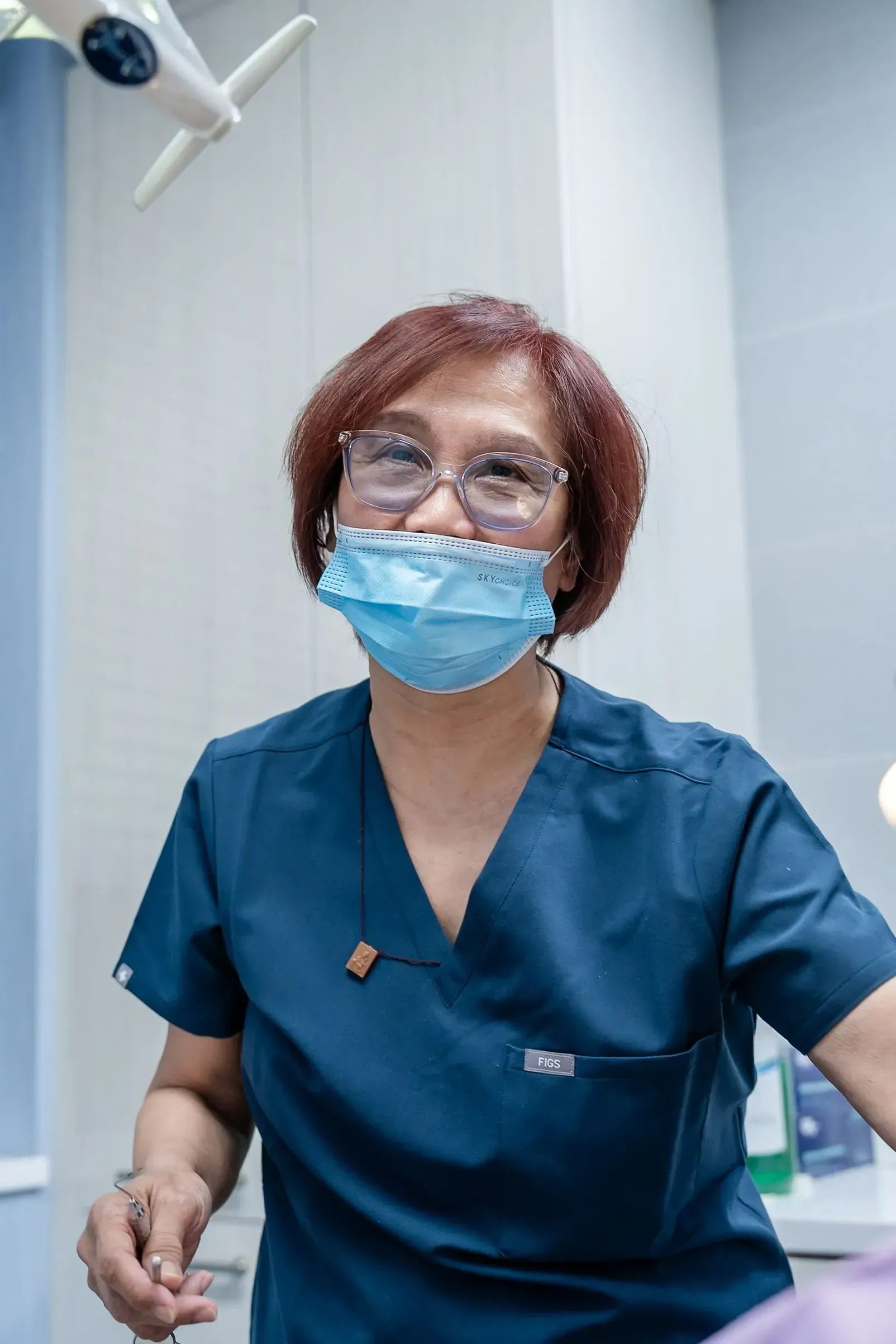 A dental team member smiling chairside