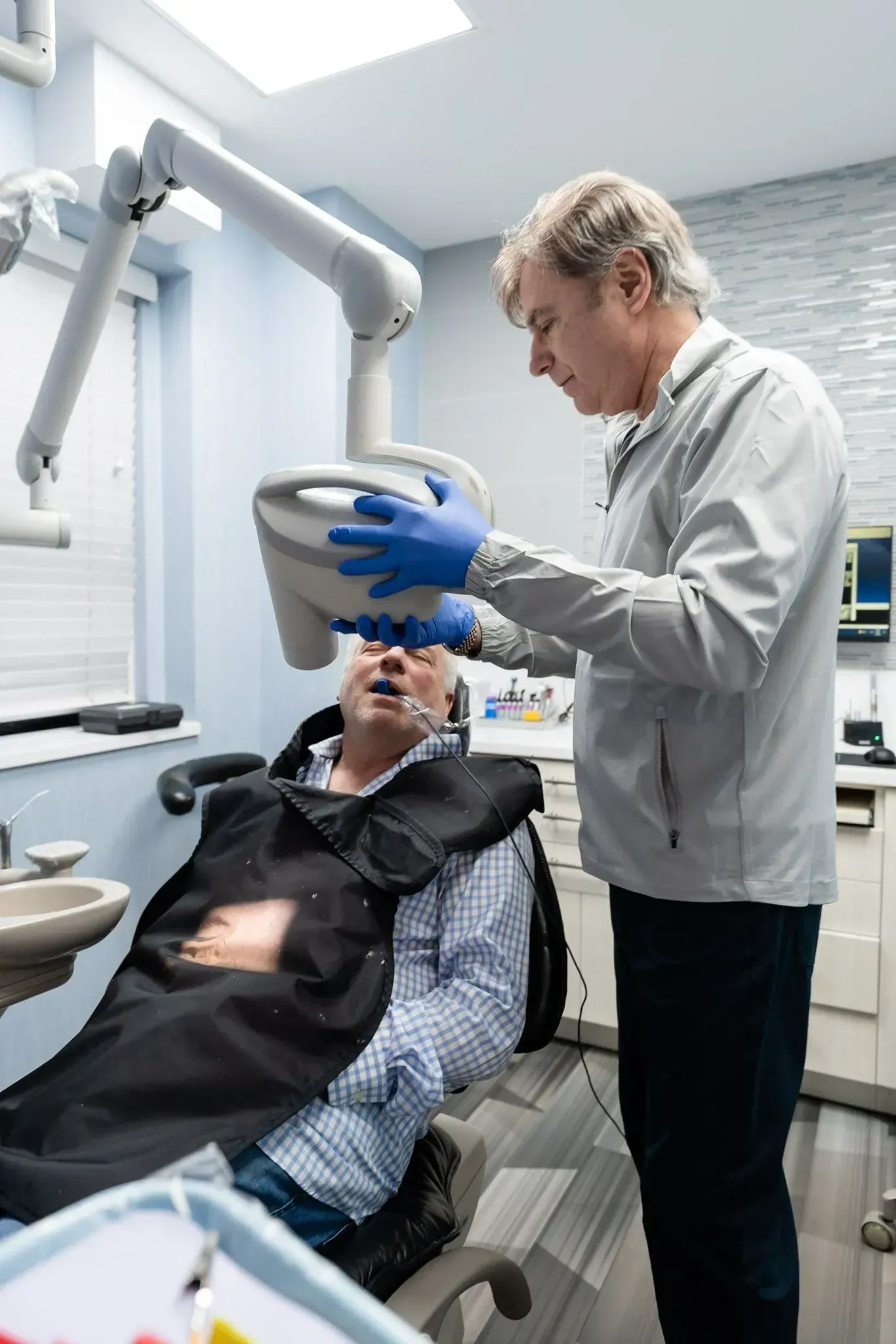 Dr. Daniel Wank positioning the x-ray unit for a patient