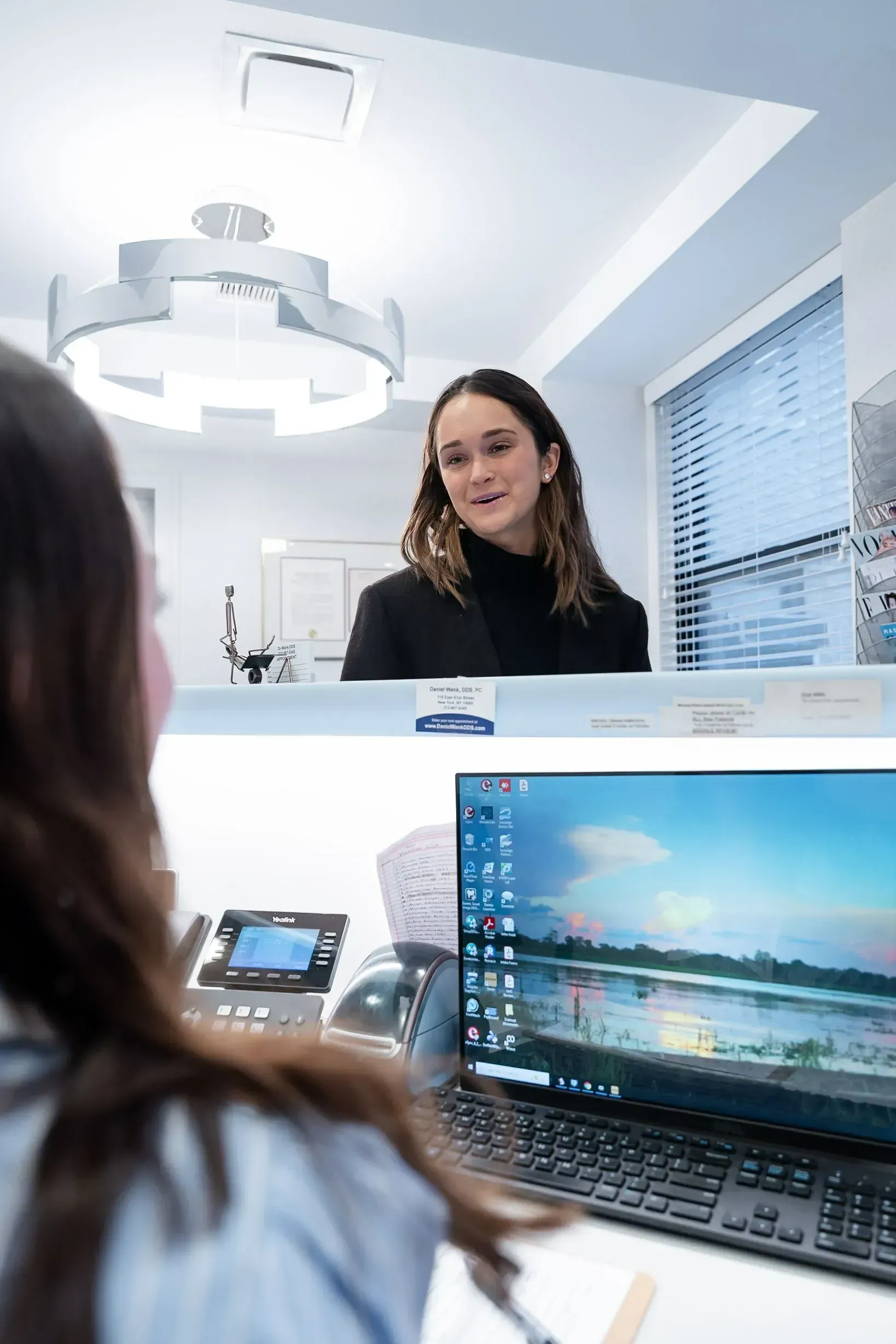 A front desk team member at the reception computer