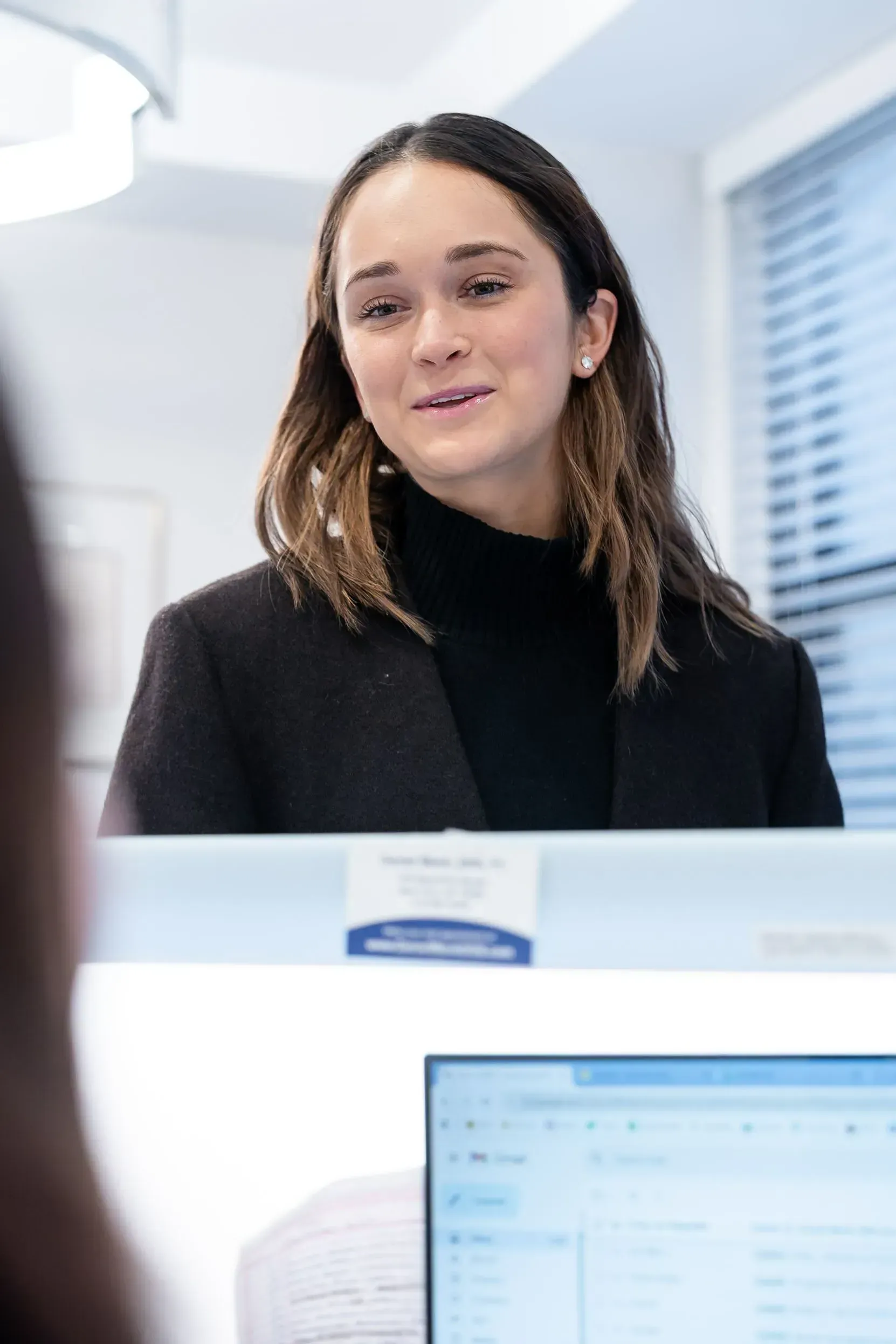 A front desk team member at the reception desk