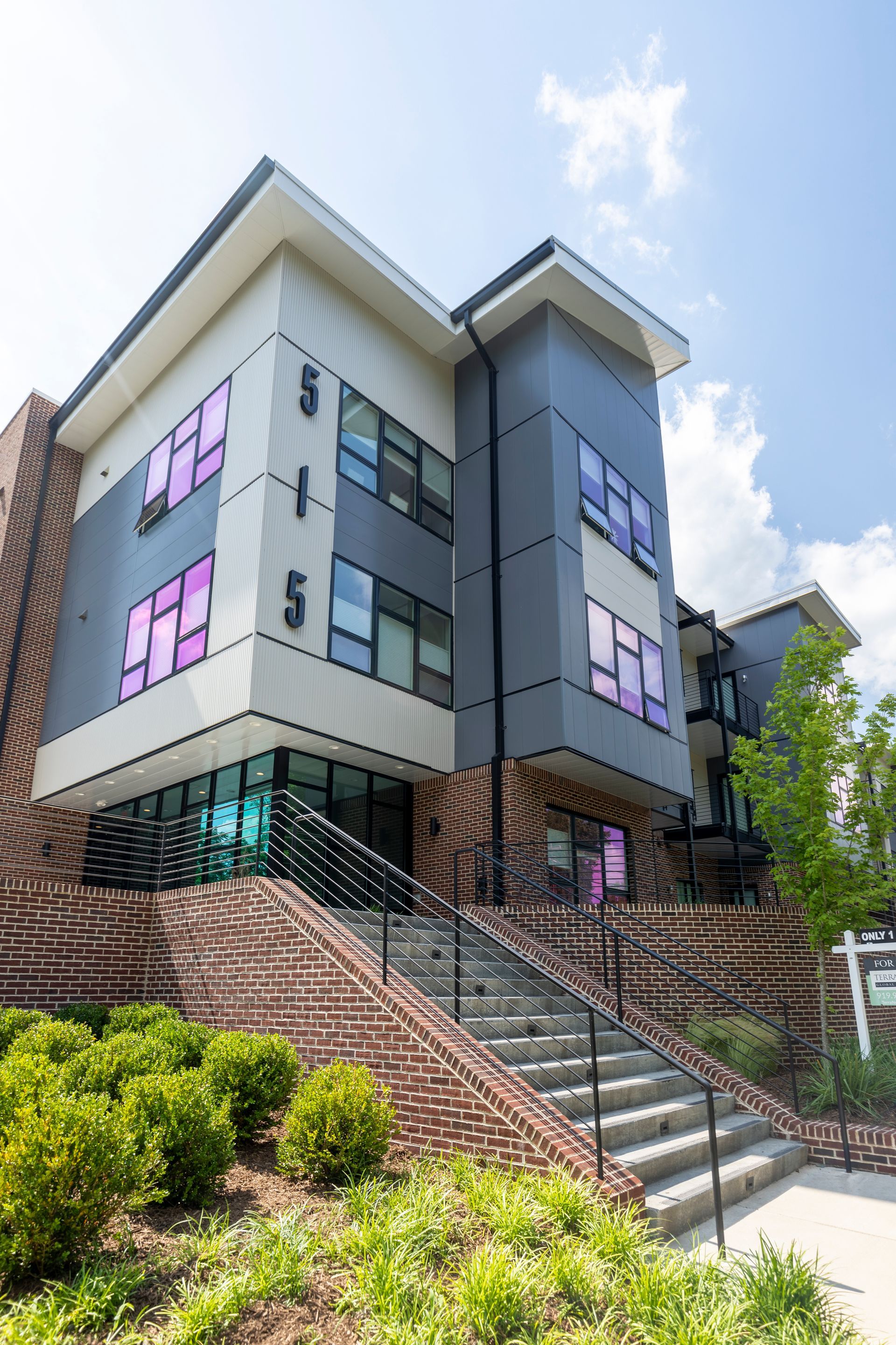 A large apartment building with stairs leading up to it.