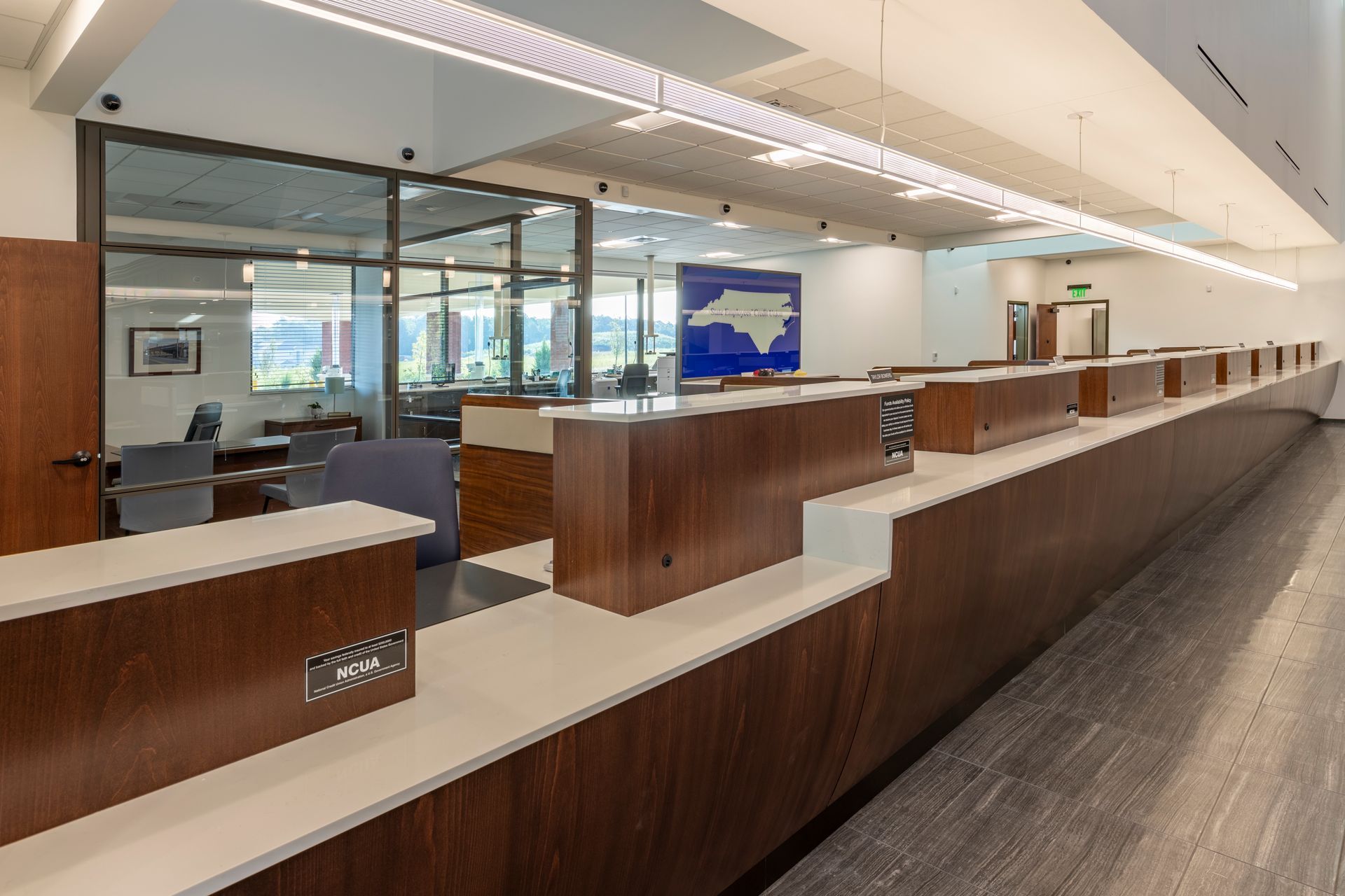 A long row of counters in a building with a map of north carolina on the wall.