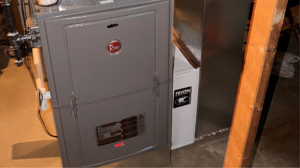 Man inspecting HVAC equipment in a metal-walled utility room with cleaning supplies nearby