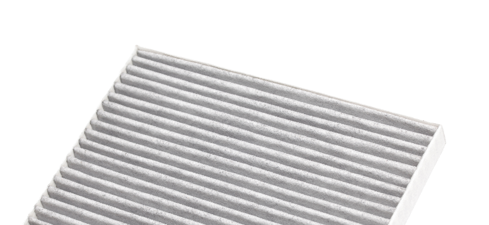 White pleated air filter panel on a white background