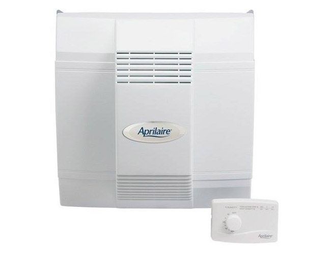 White Aprilaire whole-house humidifier with small control dial unit