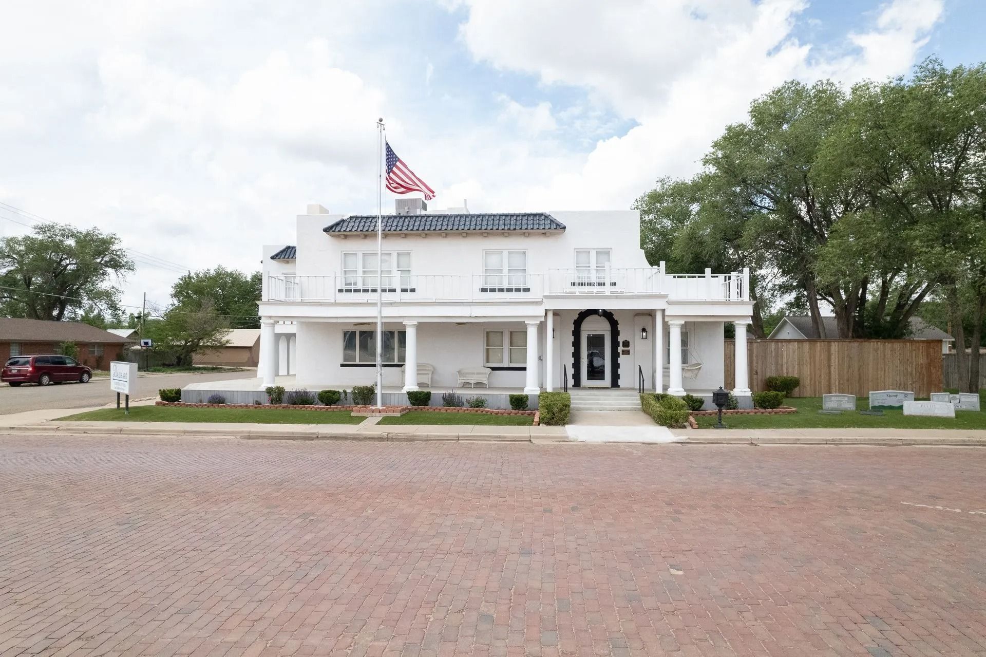 A white house with an american flag in front of it