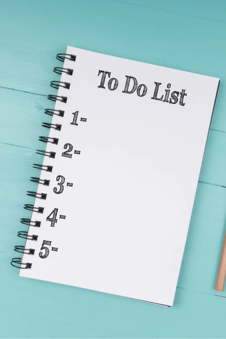 A spiral notebook with the words to do list on it