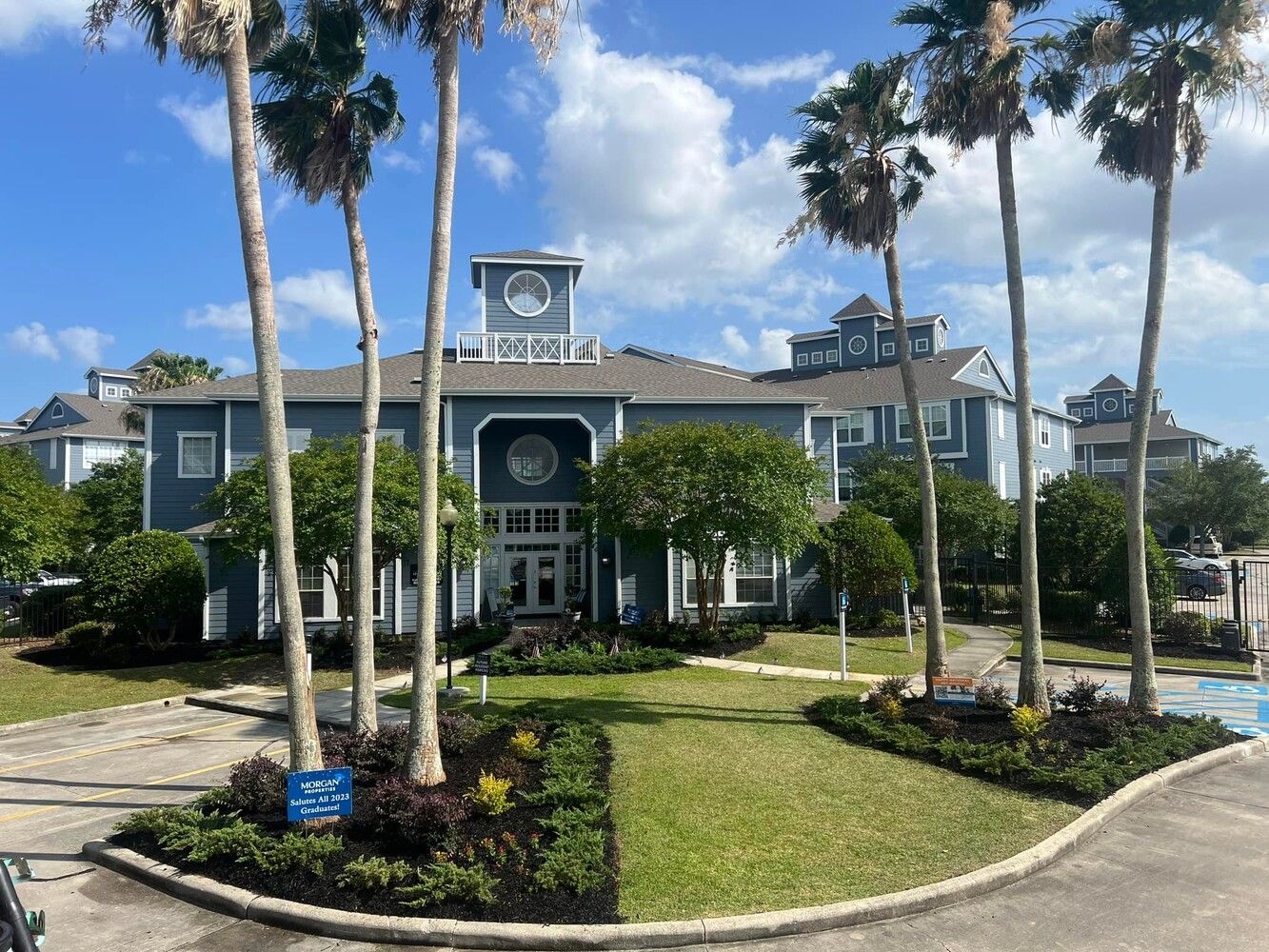 A large building with palm trees in front of it