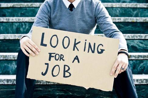 A man is holding a sign that says looking for a job