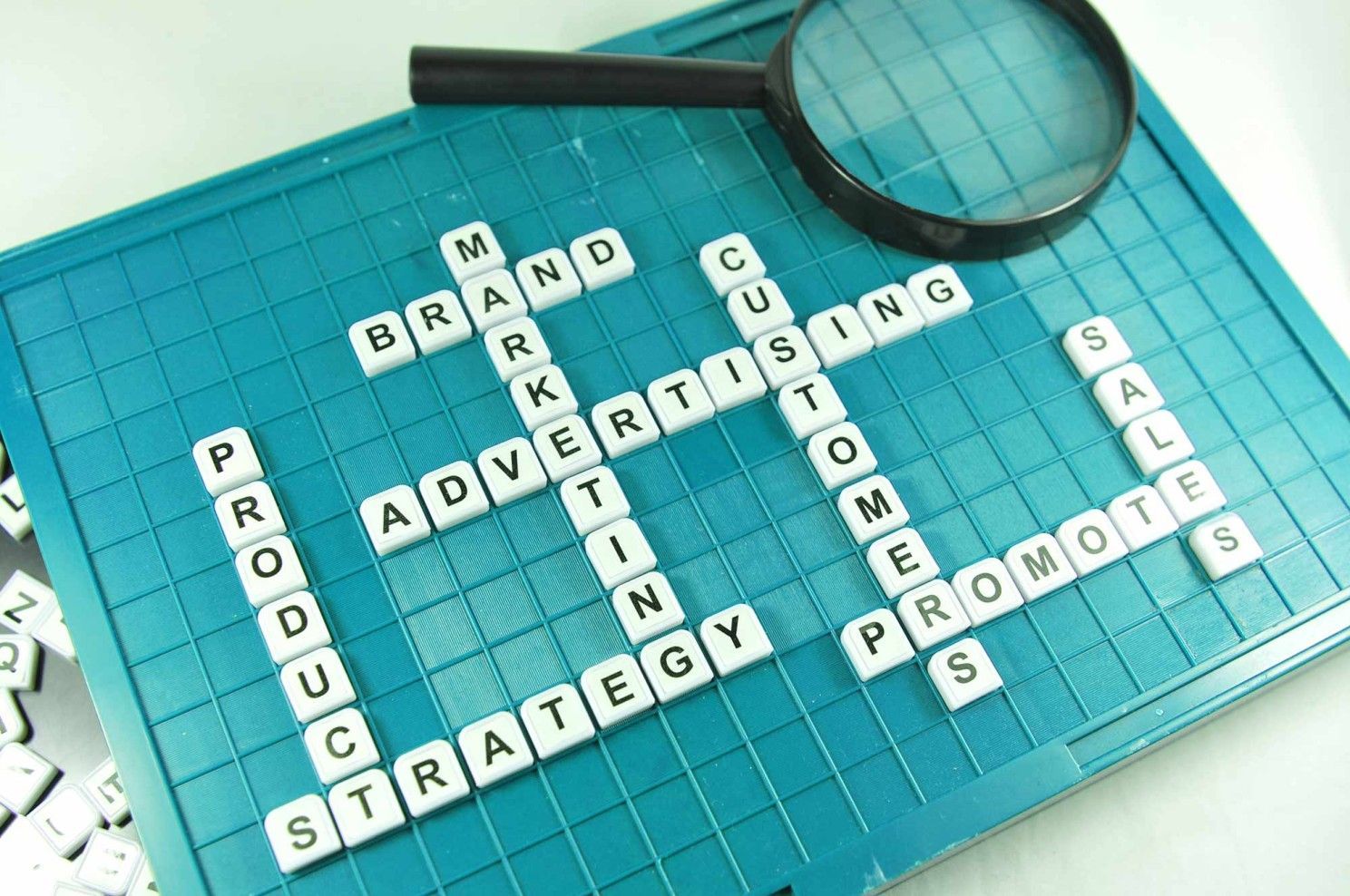 A crossword game with a magnifying glass on top of it