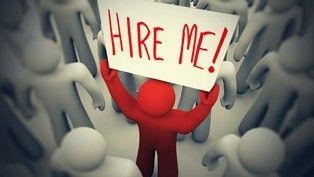 A red man is holding a sign that says `` hire me ''.