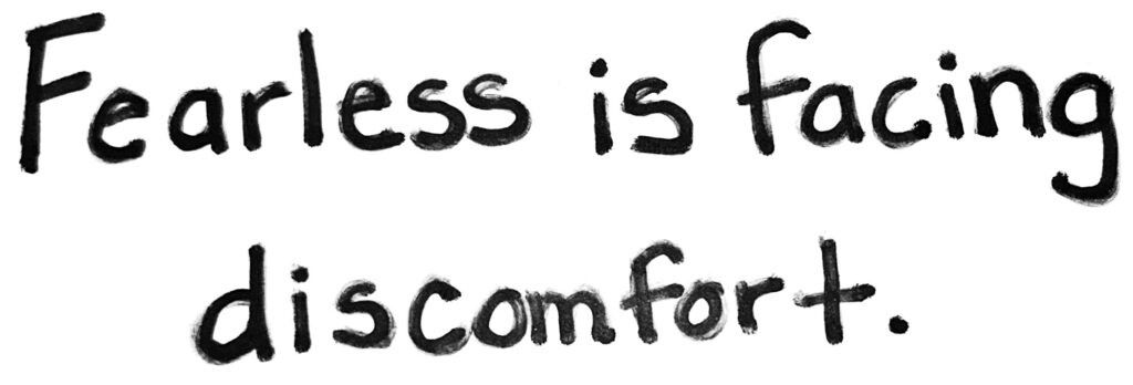 The words fearless is facing discomfort are written in black ink on a white background.