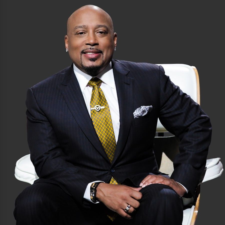 A man in a suit and tie is sitting in a chair