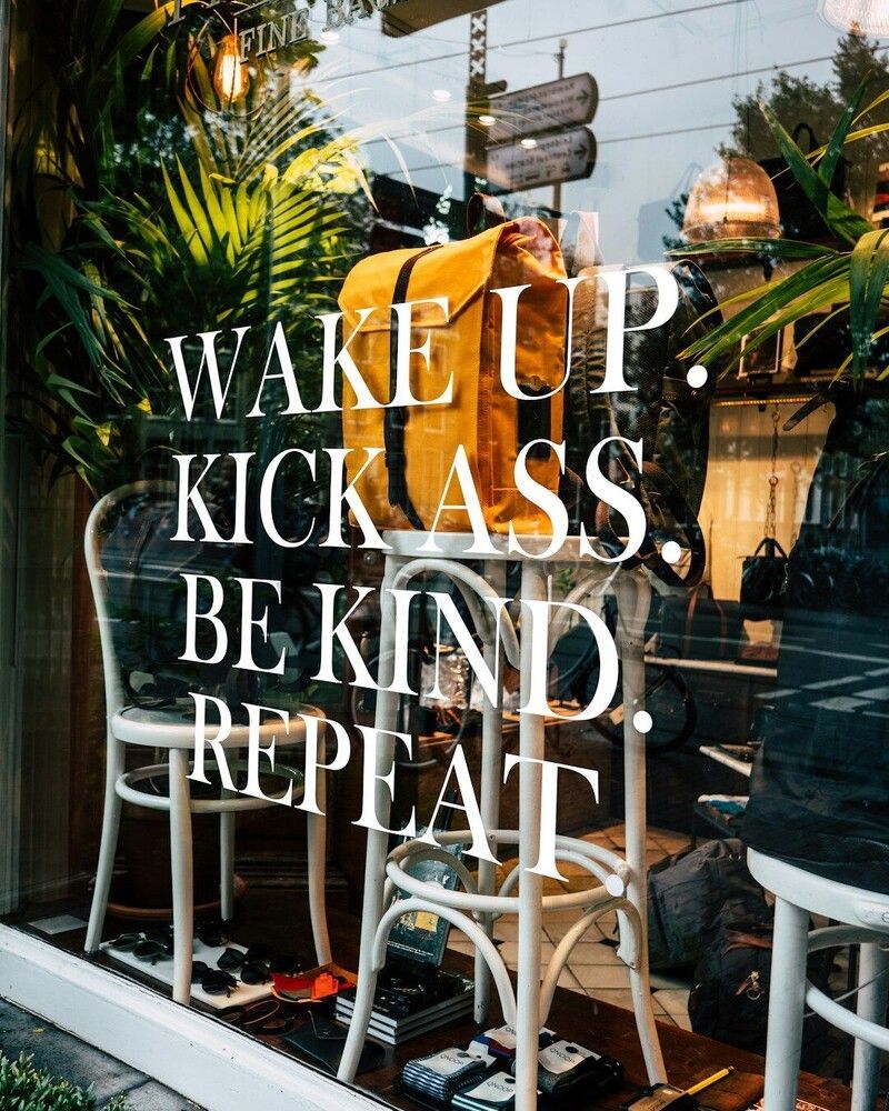 Window display with a yellow backpack, text