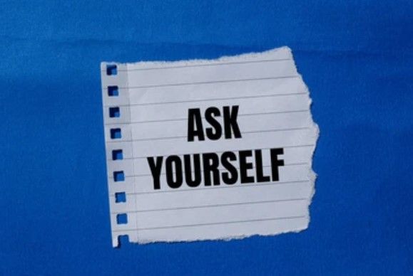 A piece of paper with the words ask yourself written on it