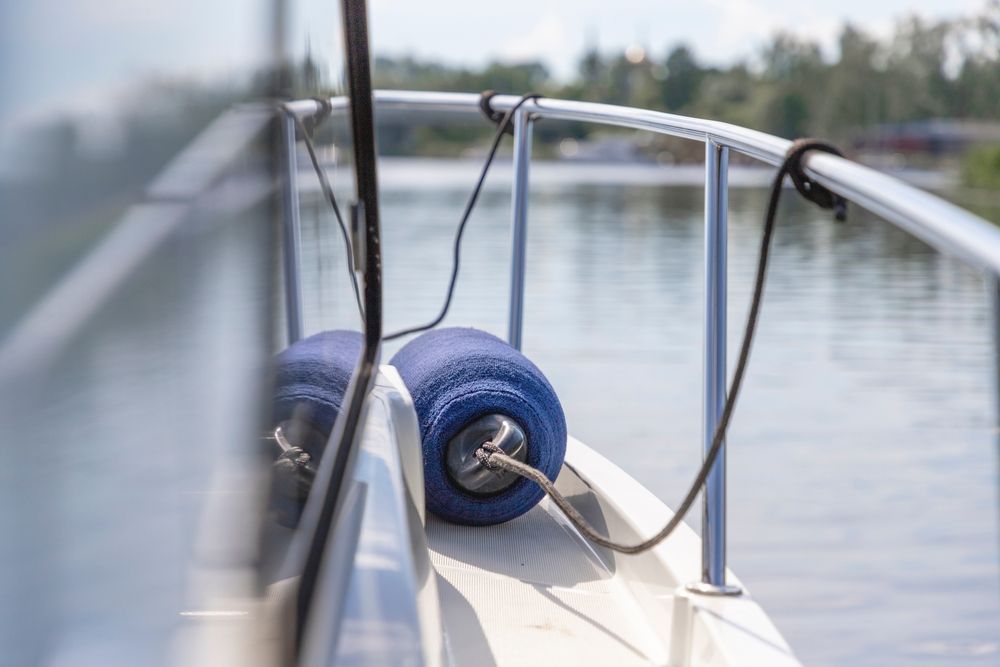 A boat is floating on top of a body of water.