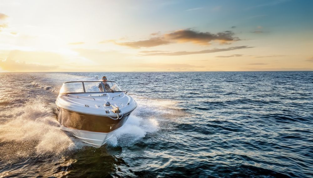 A boat is floating on top of a large body of water.