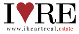 A logo for i heart real estate with a red heart
