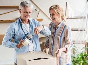 A man and a woman are packing a box together.