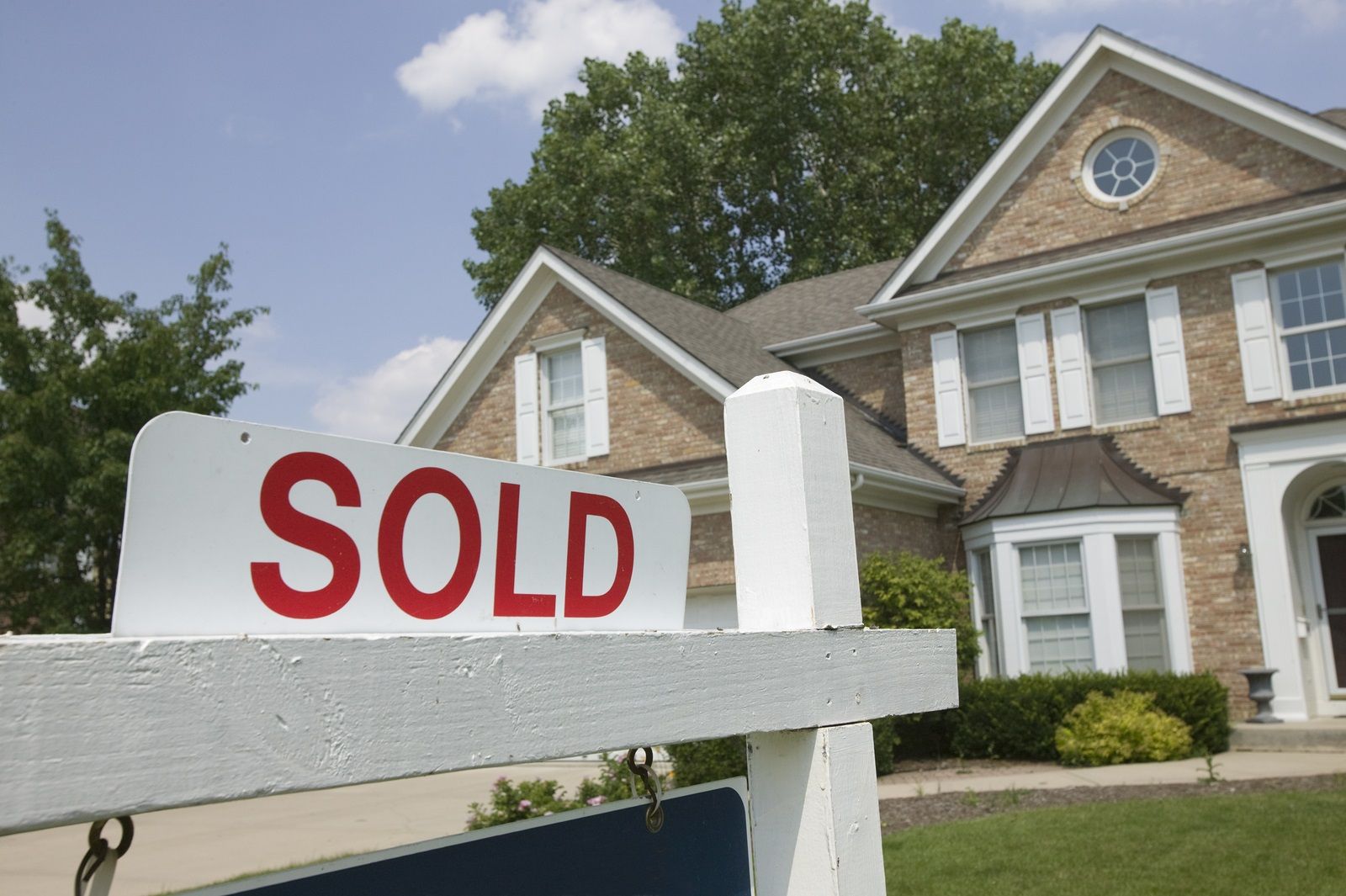 A house with a sold sign in front of it