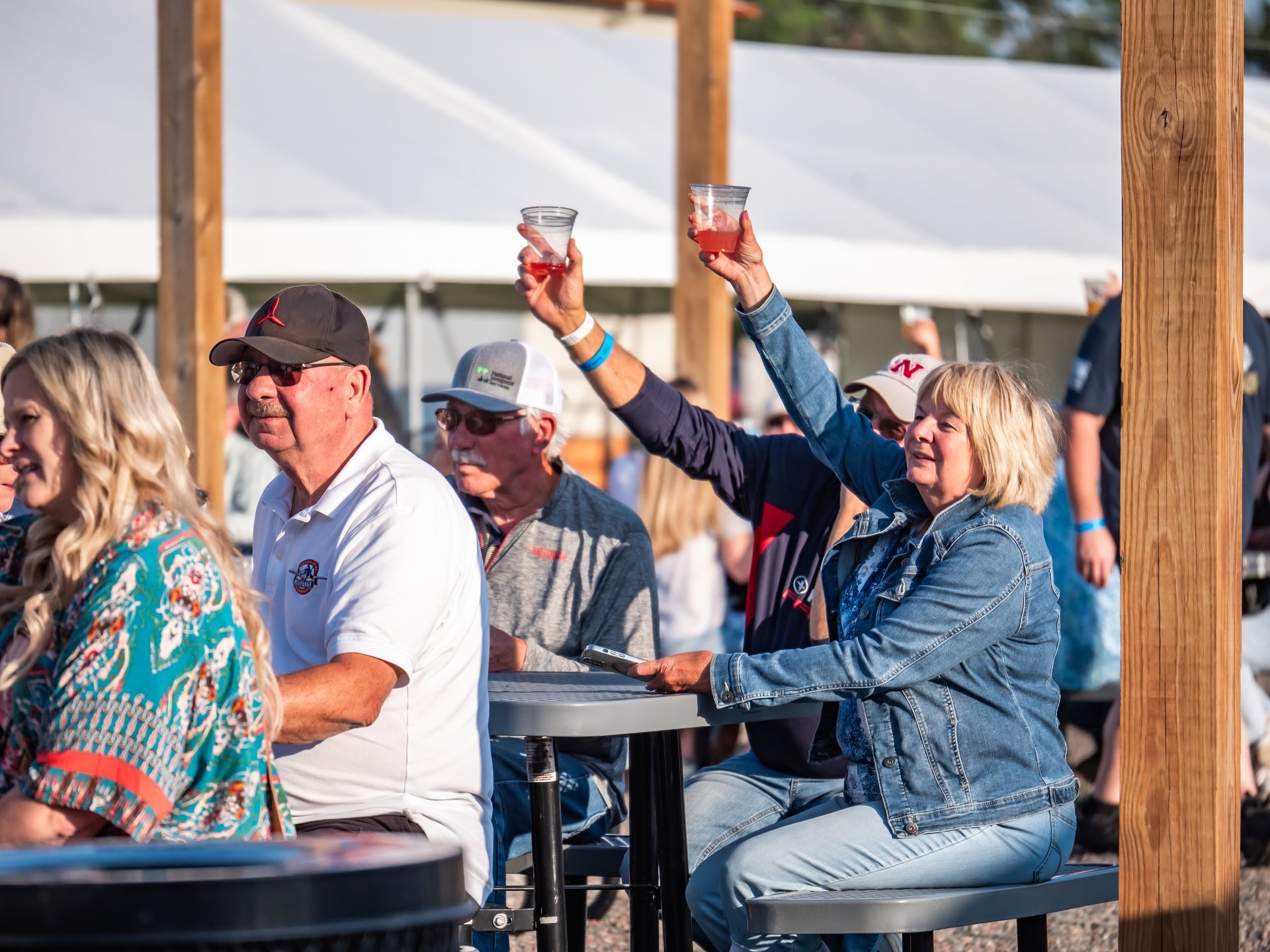 person holding a beer outside in the beer garden at pals brewing company in north platte