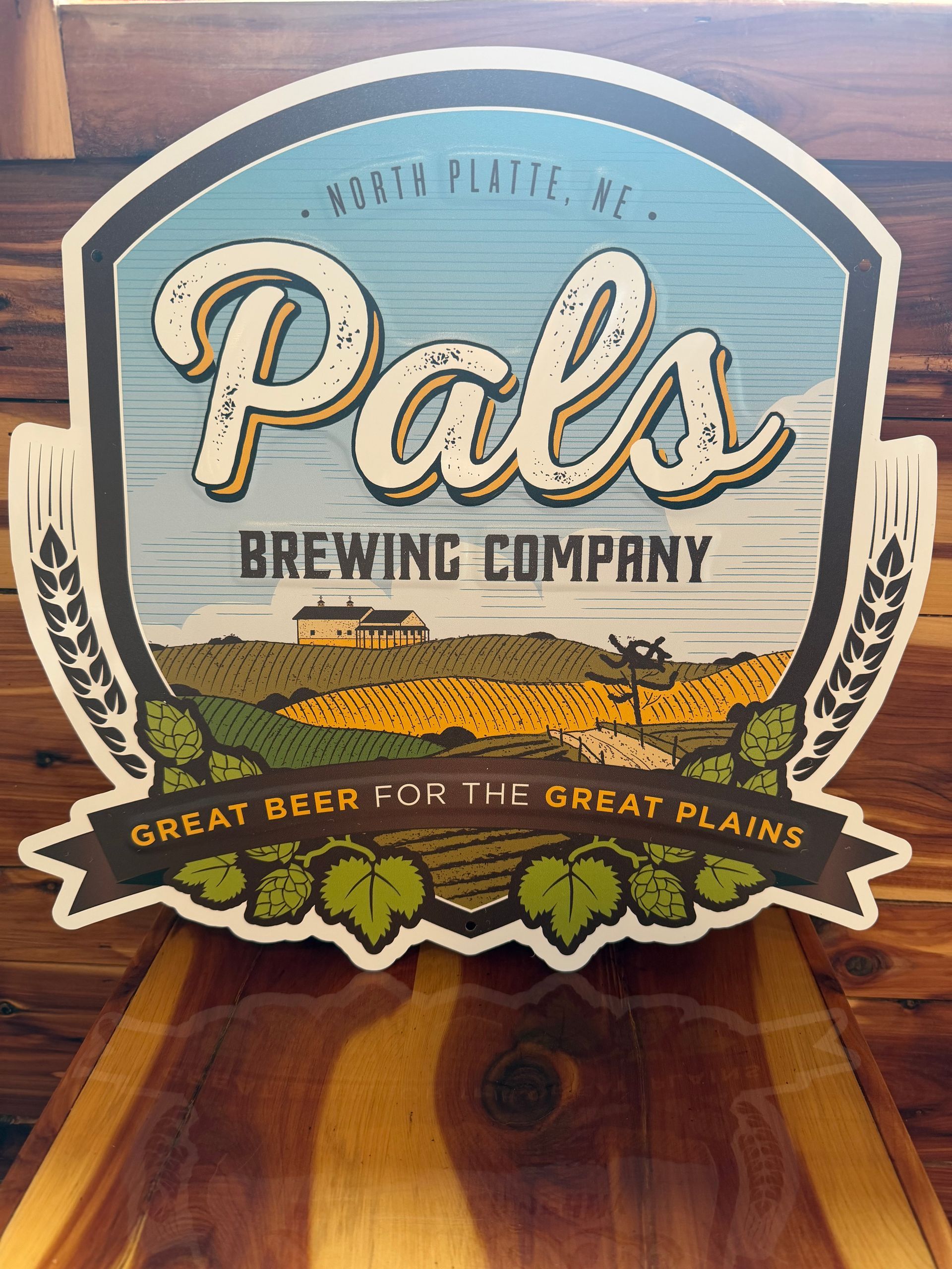 Sign for Pals Brewing Company, North Platte, Nebraska, with a landscape scene and the text "Great Beer for the Great Plains."