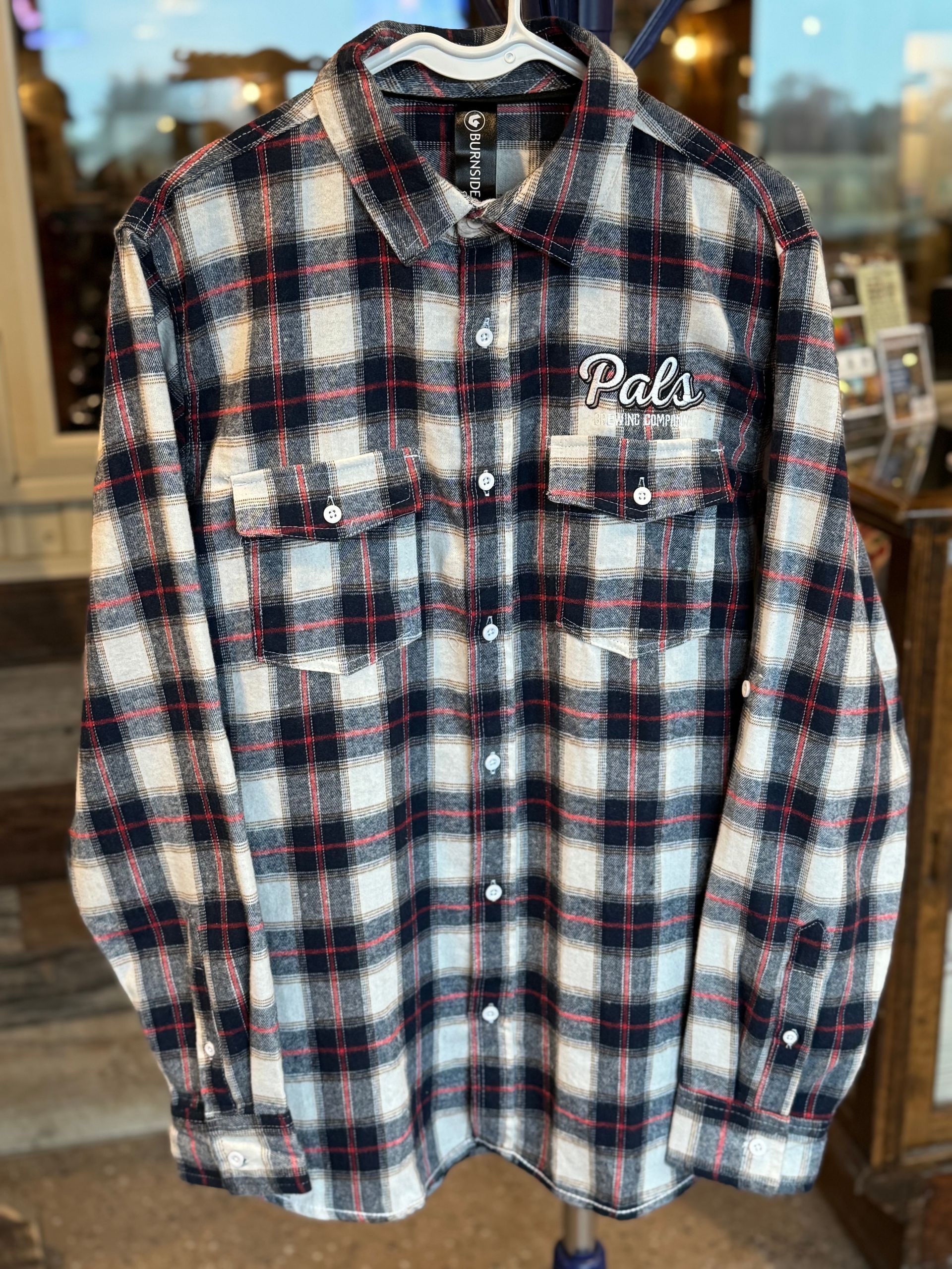 Plaid flannel shirt in black, white, and red, with 
