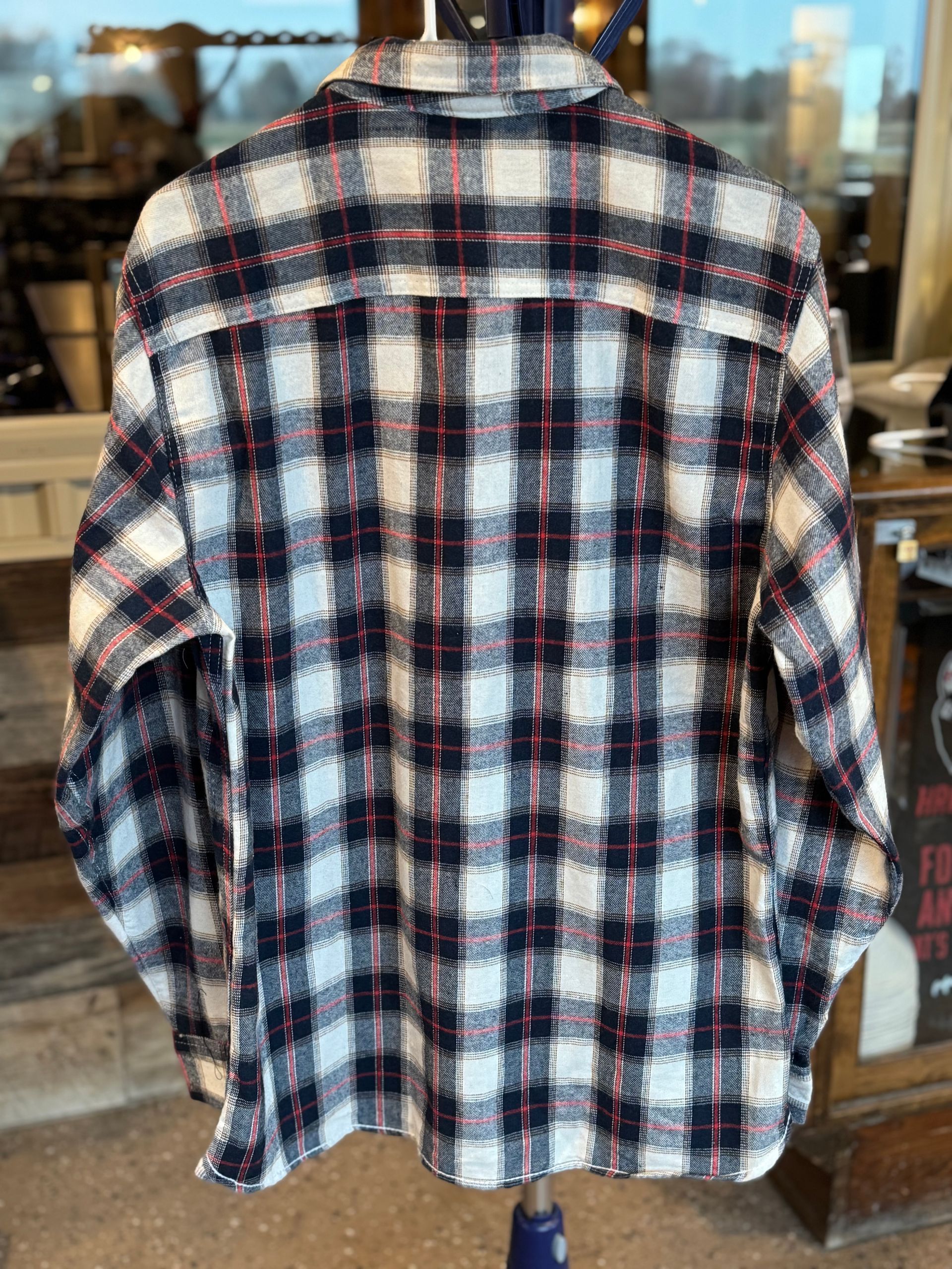 Plaid flannel shirt in black, white, and red, with 