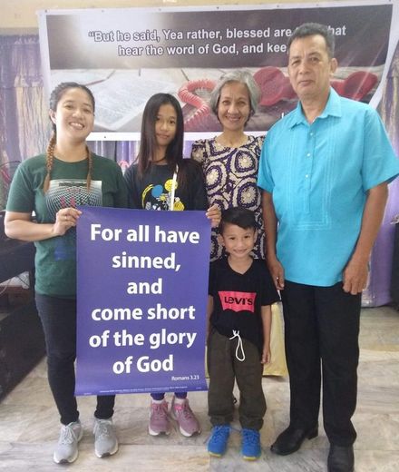 A group of people holding a sign that says for all have sinned and come short of the glory of god
