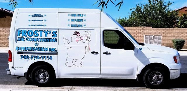 A white van with frosty 's air conditioning written on it