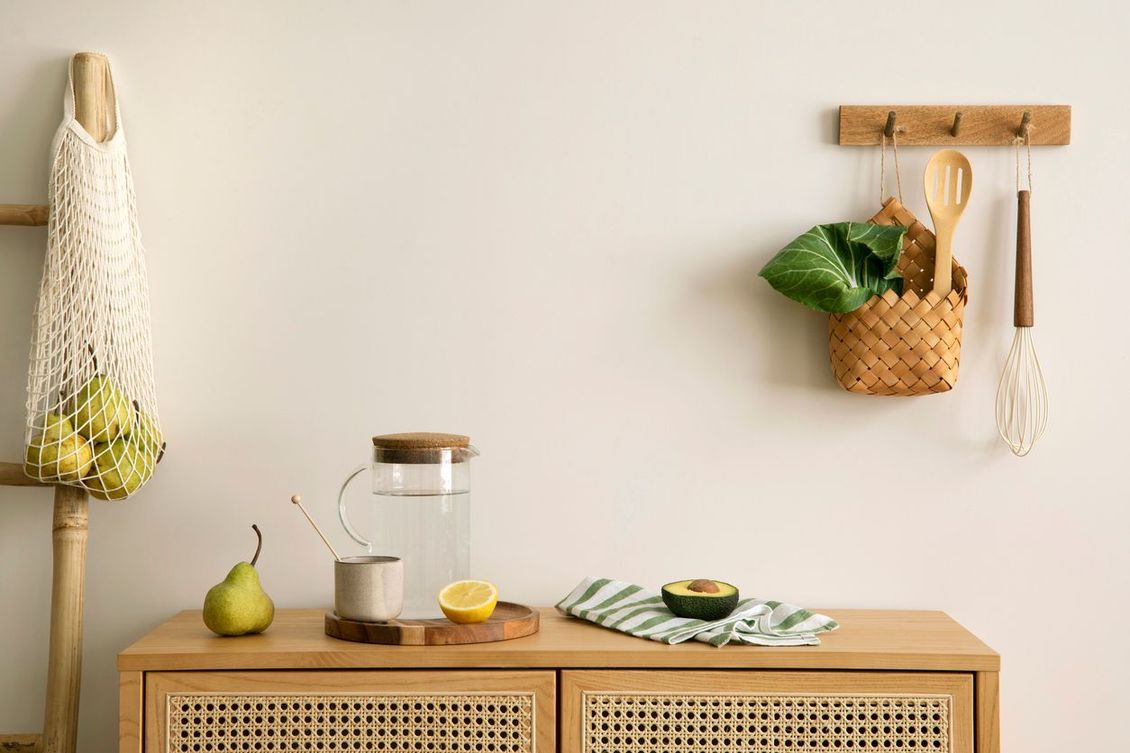 A wooden dresser with fruits and vegetables on it in a kitchen.