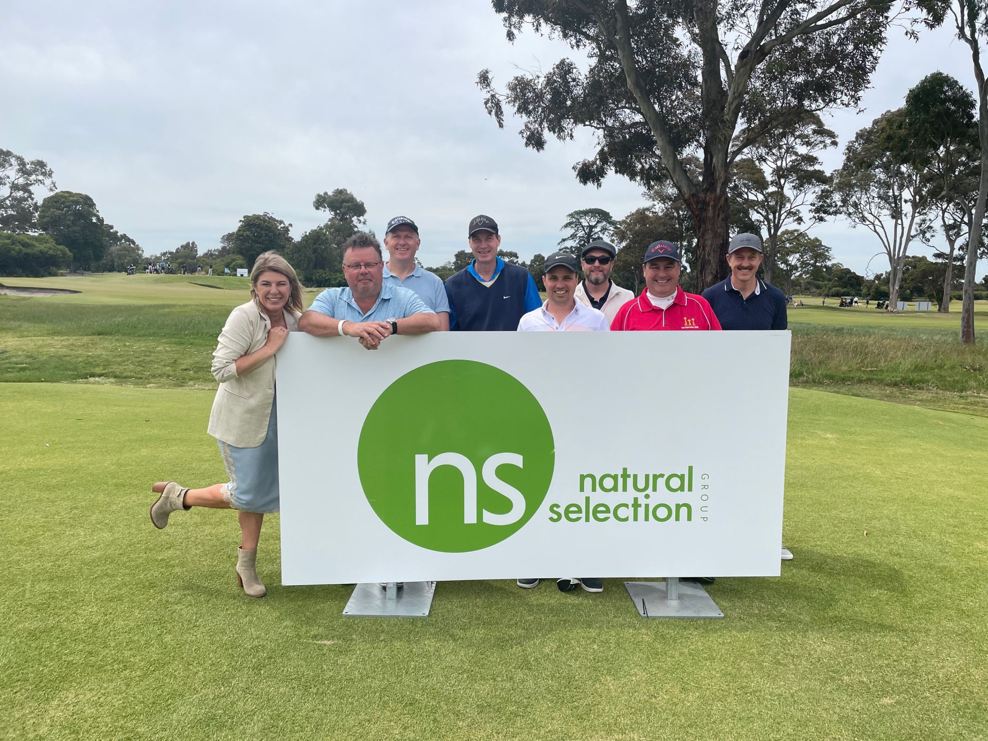 A group of people standing behind a 