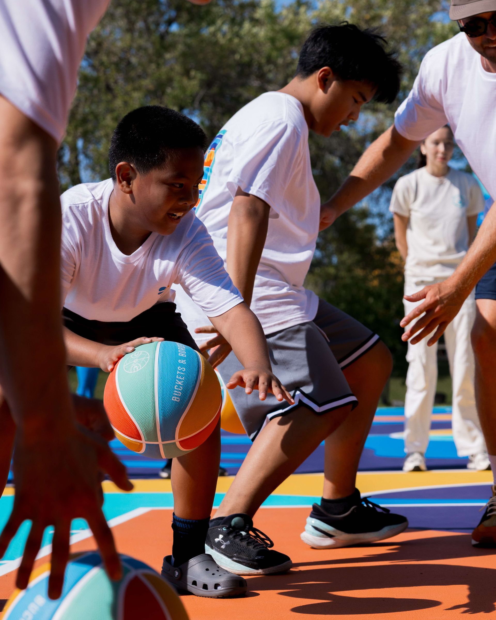 Youth playing on a refurbished community basketball court