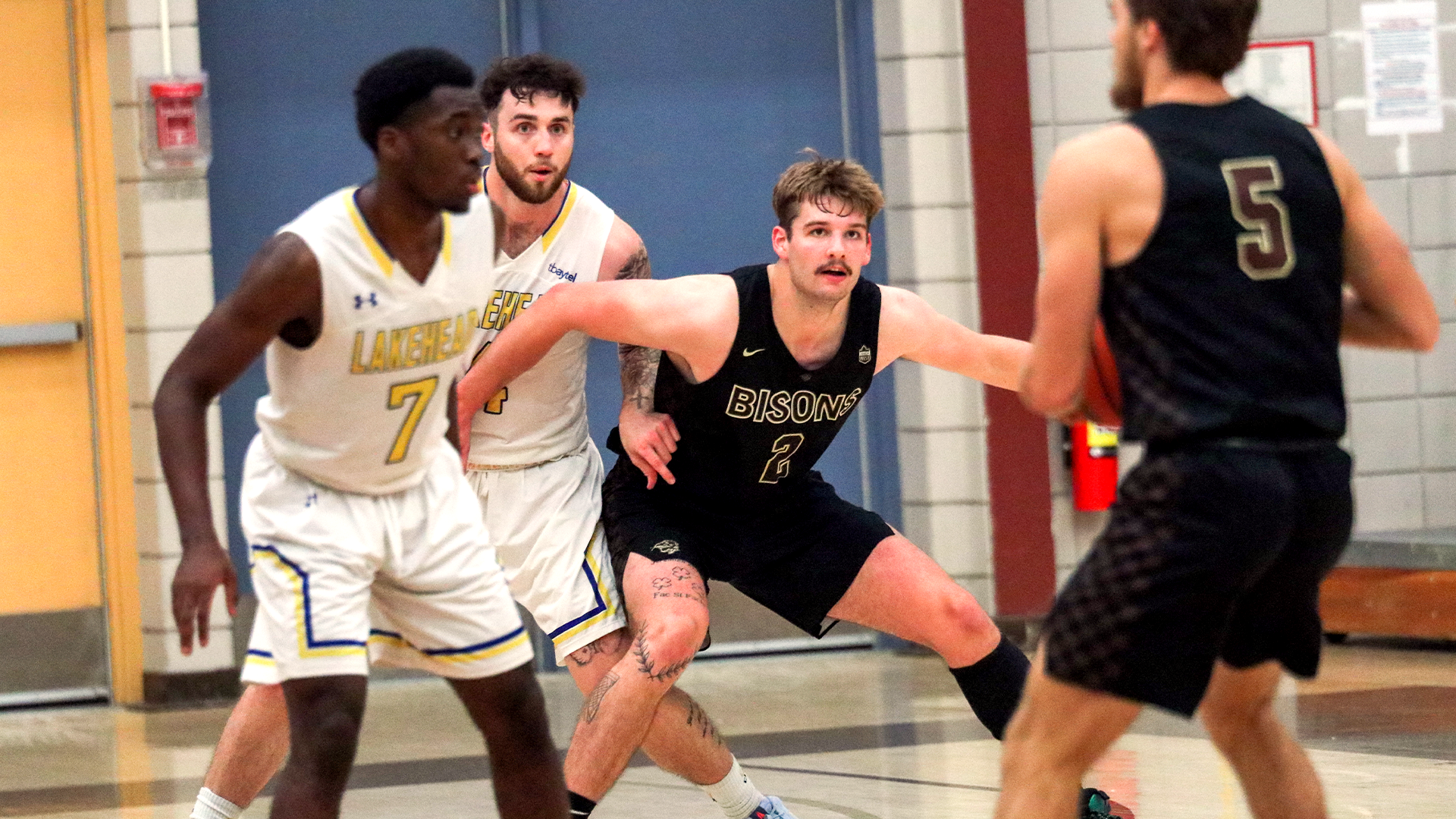 Simon Hildebrandt of the Winnipeg Sea Bears posts up on former teammate Tyler Sagl, during a Manitoba Bisons and Lakehead Thunderwolves preseason game.