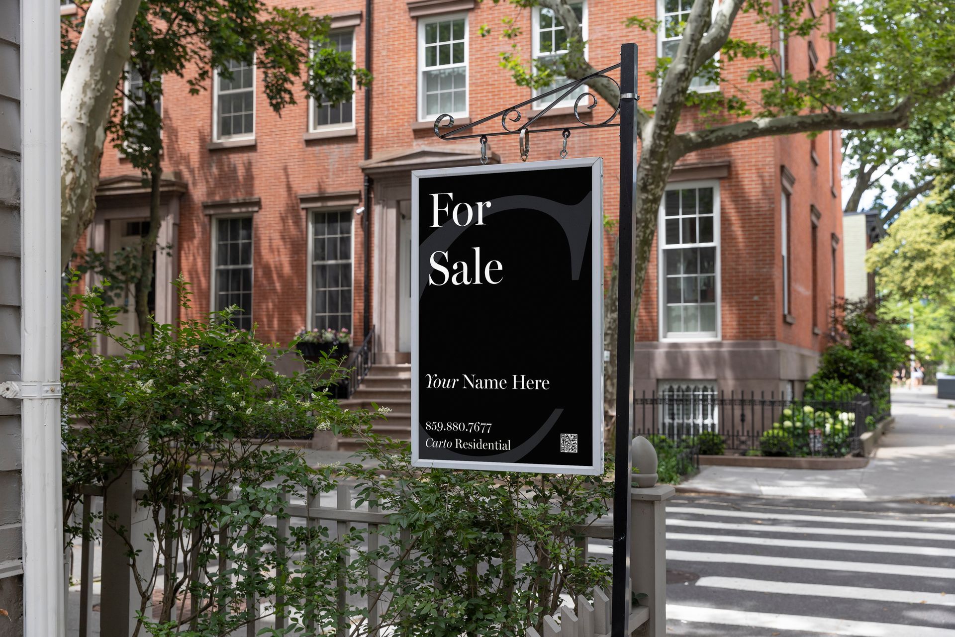 Carto Residential sign in front of brick townhomes