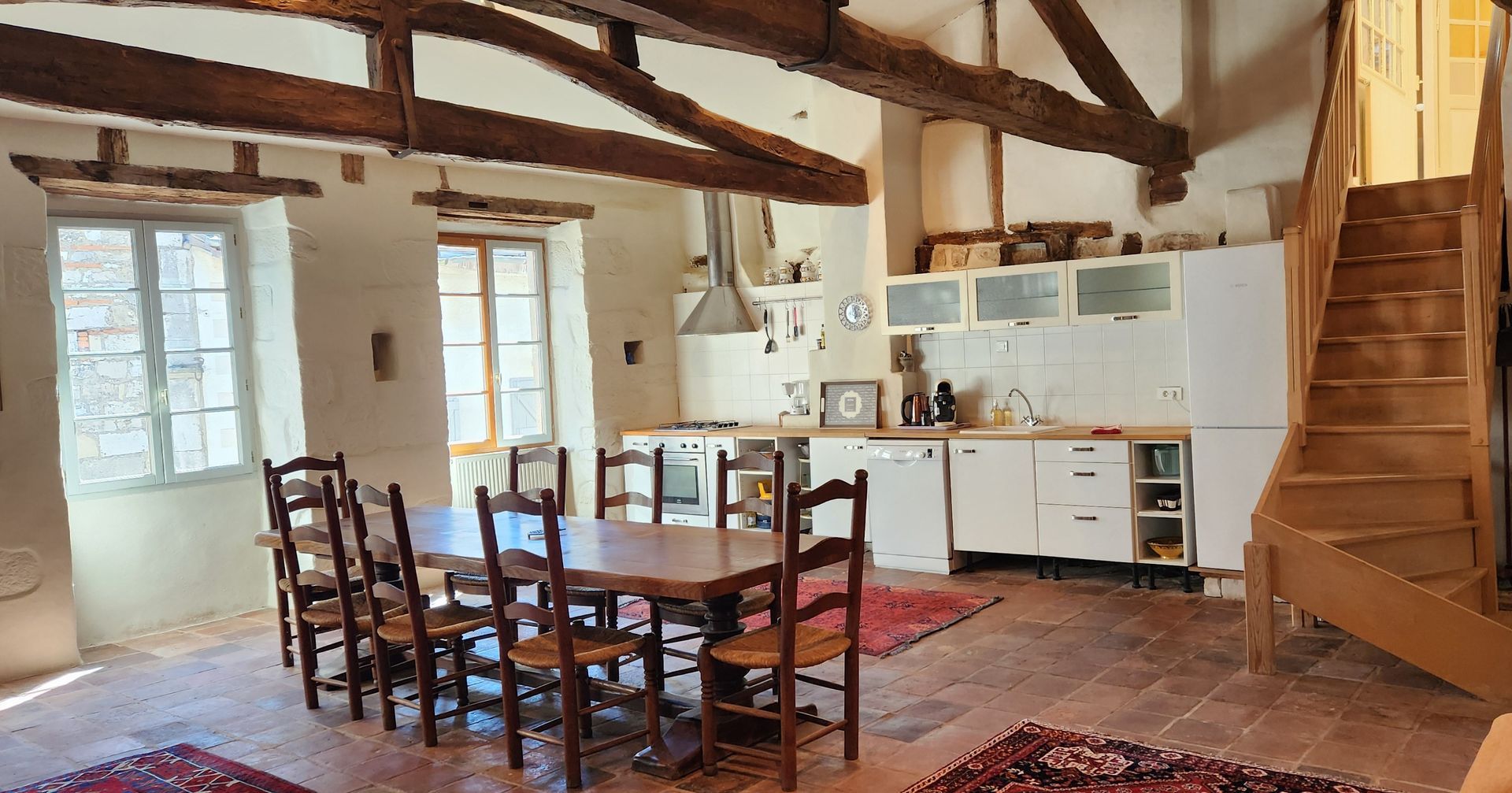 There is a dining table and chairs in the middle of the room.
