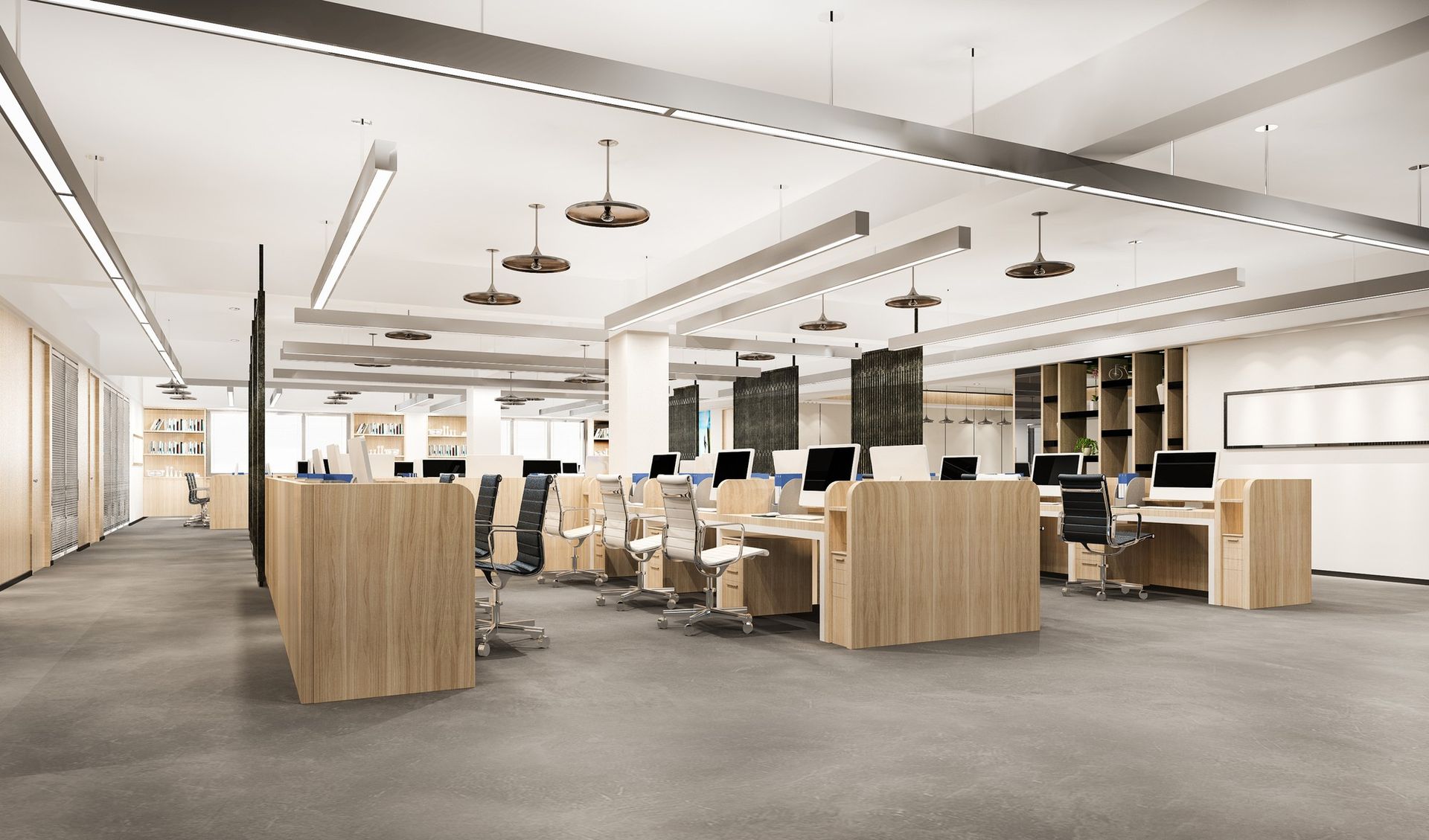 An empty office with wooden desks and chairs and a lot of windows.