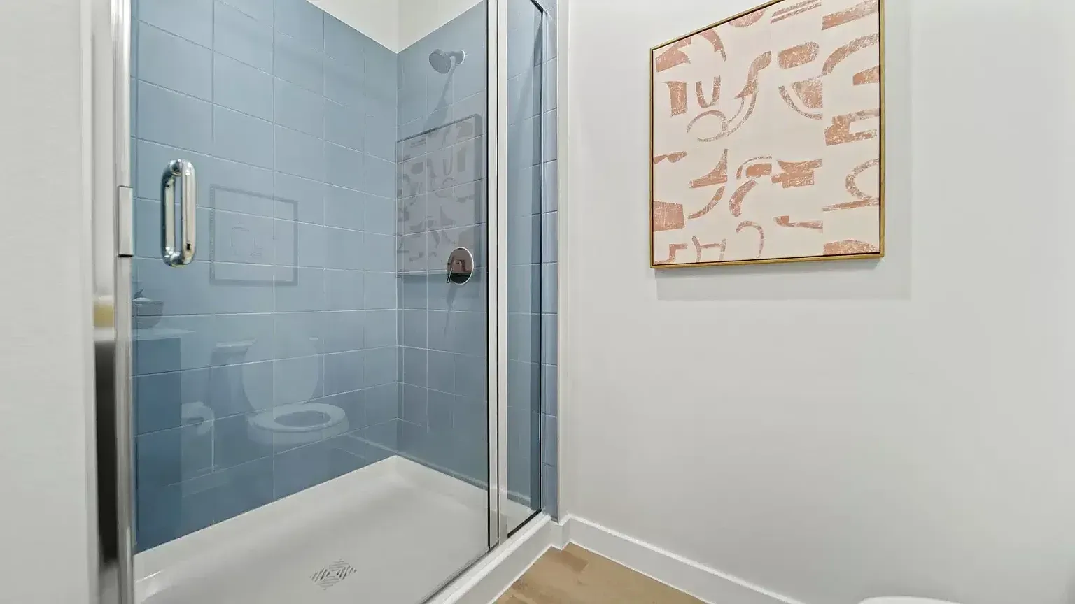 Shower and toilet in a modern bathroom.