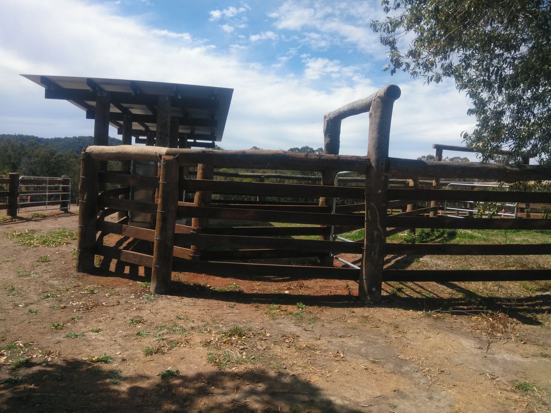 A Stable Fence Surrounds A Field Of Grass And Dirt — John Stark Fencing In West Woombye, QLD