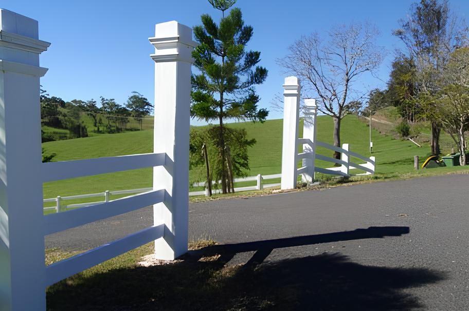 A White Fence With A Grassy Field In The Background — John Stark Fencing In Bli Bli, QLD