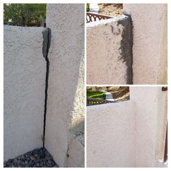Cracked stucco wall repaired with gray filler, against a backdrop of a yard.