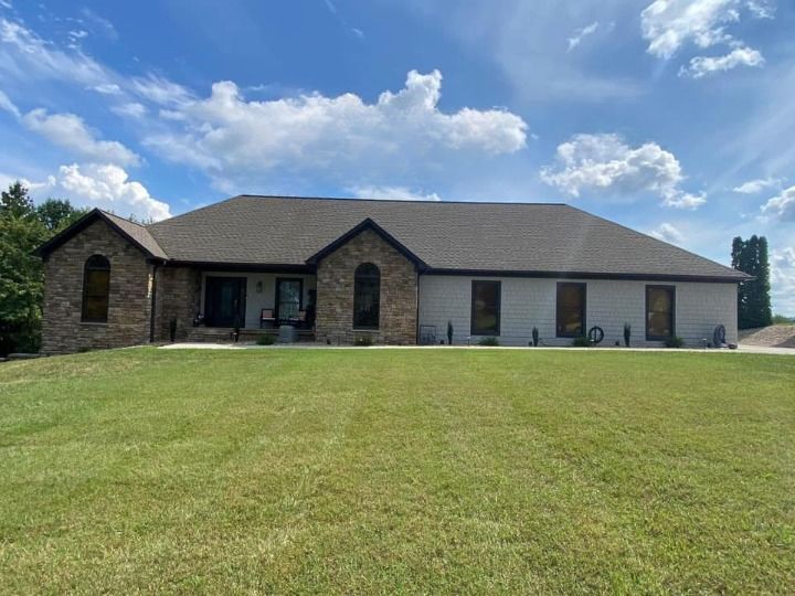 A large house with a large lawn in front of it.