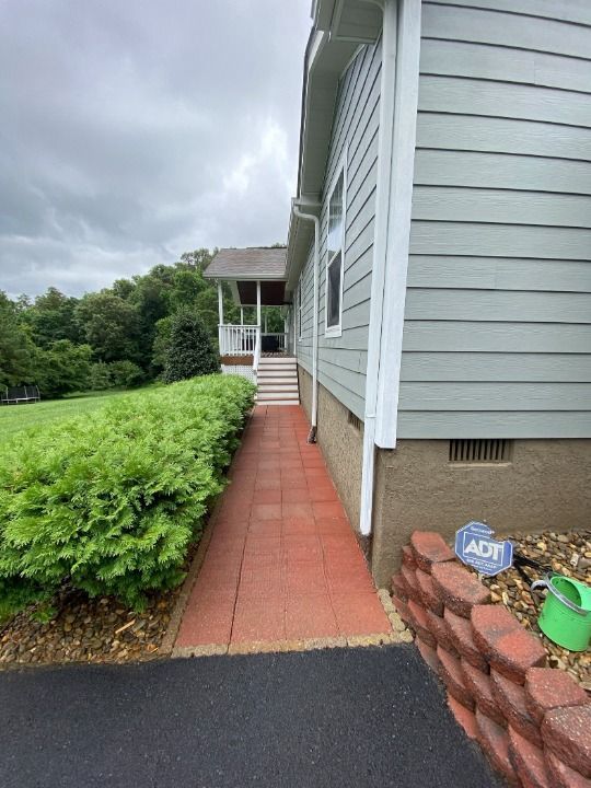 A house with a red walkway leading to the front door.