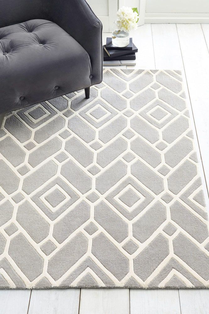 A Gray And White Carpet Is Sitting On A White Floor Next To A Chair — Affordable Carpets Woolgoolga In Grafton, NSW