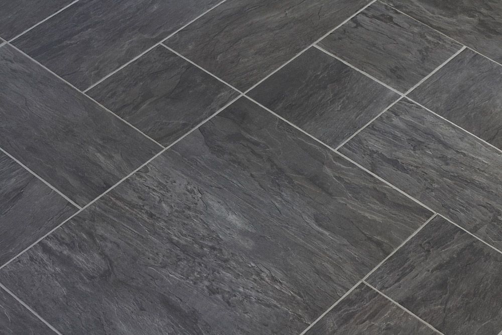A Close Up Of A Black Tile Floor With White Grout — Affordable Carpets Woolgoolga In Woolgoolga, NSW